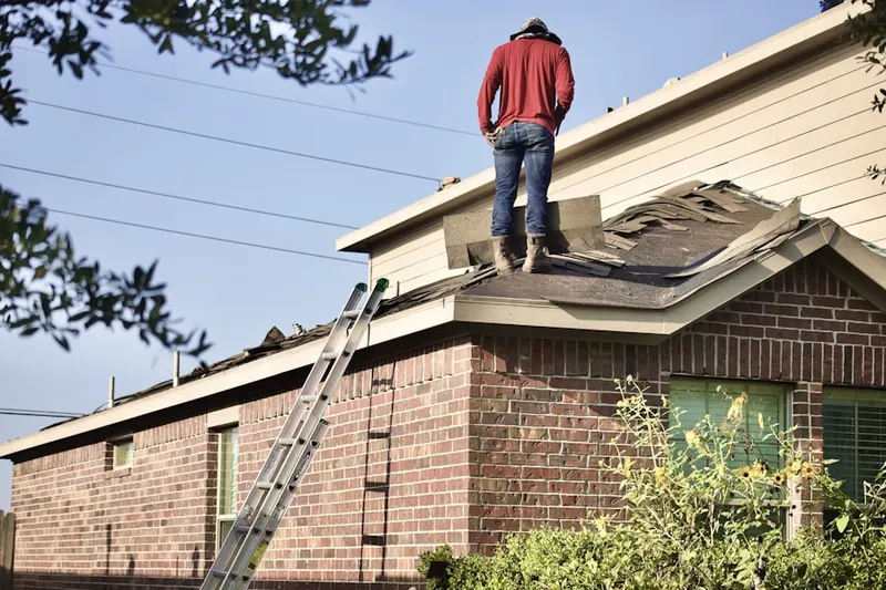Professional roofer working on a residential roof in Prairie Ridge